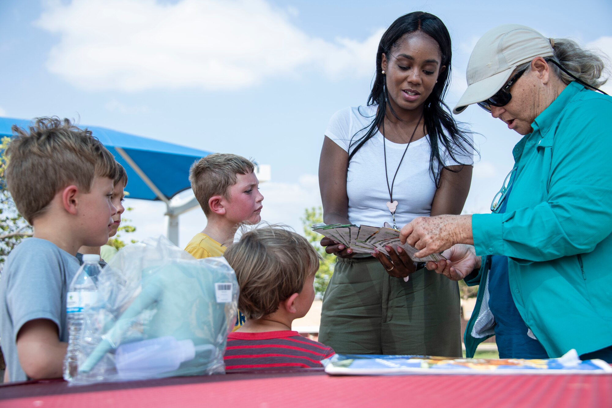 Cherrell Williams, 97th Force Support Squadron exceptional family member, (center) helps Altus families select seeds during a garden workshop at Altus Air Force Base, Oklahoma, June 25, 2021. The workshop was held in preparation for the opening of the community garden to educate families on what they can grow. (U.S. Air Force photo by Staff Sergeant Cody Dowell)