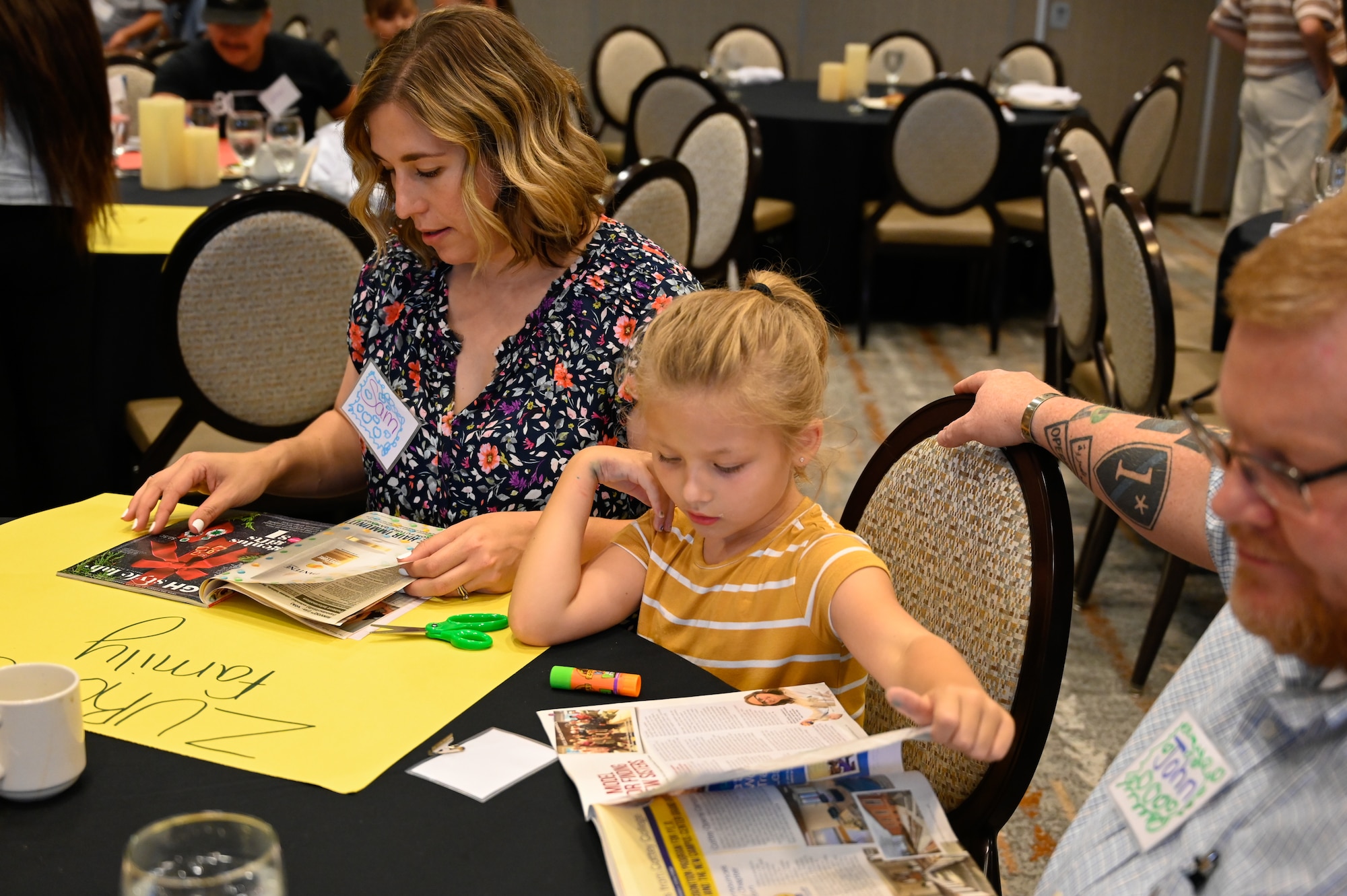 Samantha Zurcher, works on a family craft with her husband and daughter at the Strong Bonds Family event