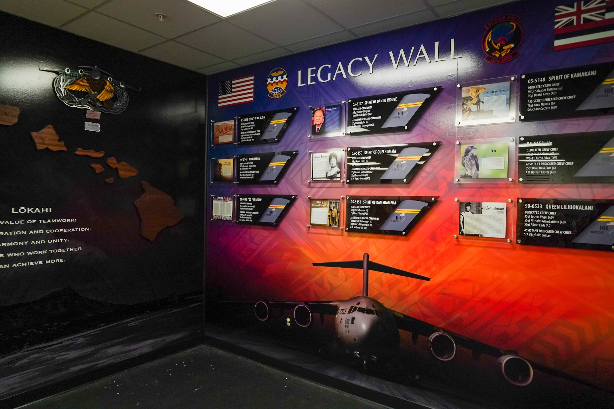 Maj. Ryan White, 15th Aircraft Maintenance Squadron commander, reveals the new Legacy Wall display inside the maintenance building at Joint Base Pearl Harbor-Hickam, Hawaii, August 16, 2021. The project took over a year to complete and took several Airmen to design the display. (U.S. Air Force photo by Airman 1st Class Makensie Cooper)