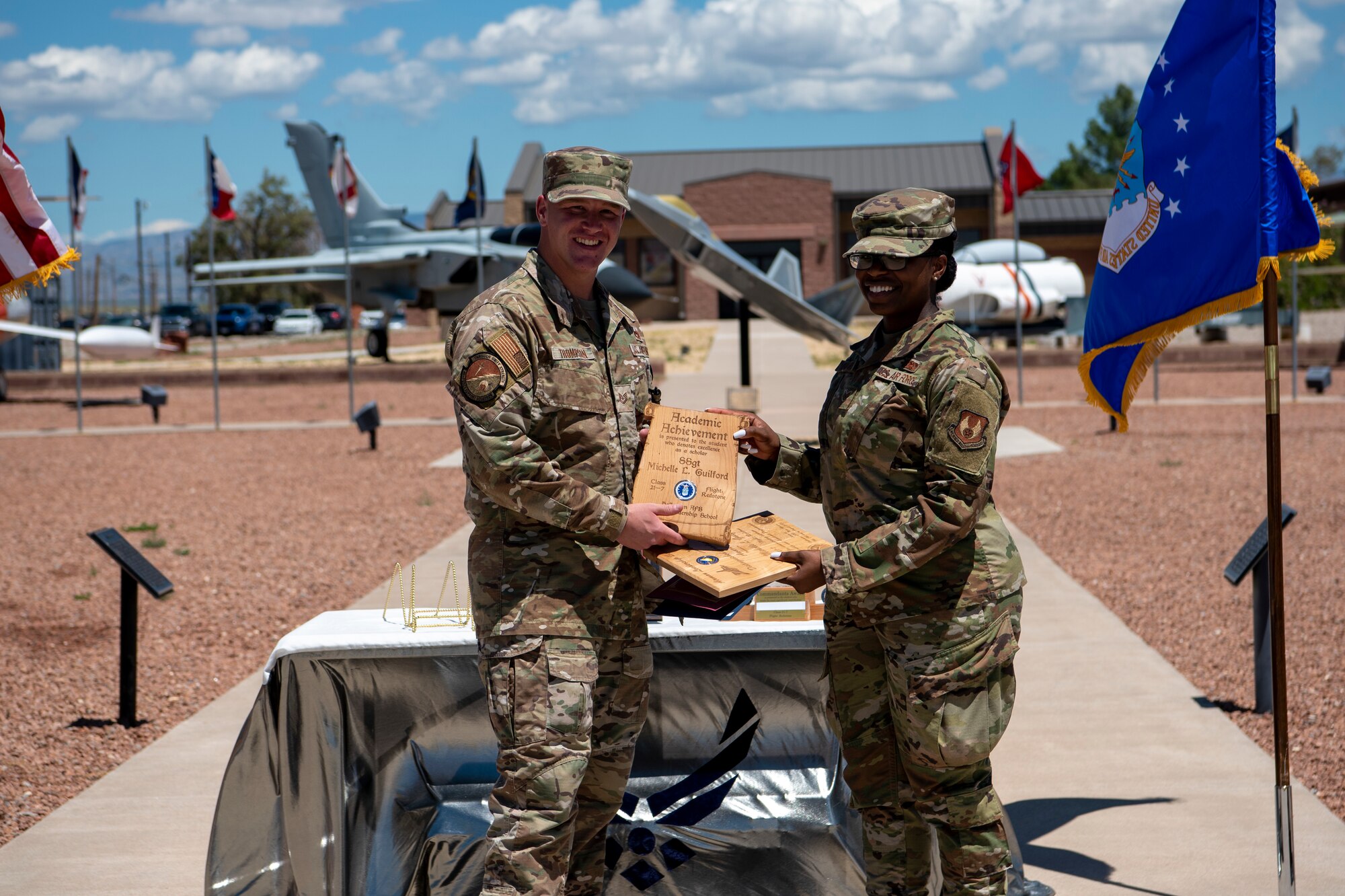 Staff Sgt. Michelle L. Guilford, Airman Leadership School graduate, accepts the academic achievement award during the graduation of ALS class 21-7, Aug. 19, 2021, on Holloman Air Force Base, New Mexico. The academic award is presented to the student with the highest overall average on all academic evaluations. (U.S. Air Force photo by Airman 1st Class Jessica Sanchez)