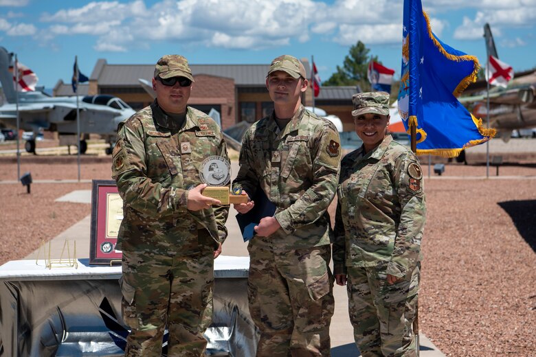 Staff Sgt. Colton T. Neal, Airman Leadership School graduate, accepts the commandant leadership award during the graduation of ALS class 21-7, Aug. 19, 2021, on Holloman Air Force Base, New Mexico. The commandant leadership award is selected by the ALS commandant and is presented to the student who demonstrates exemplary leadership characteristics. (U.S. Air Force photo by Airman 1st Class Jessica Sanchez)