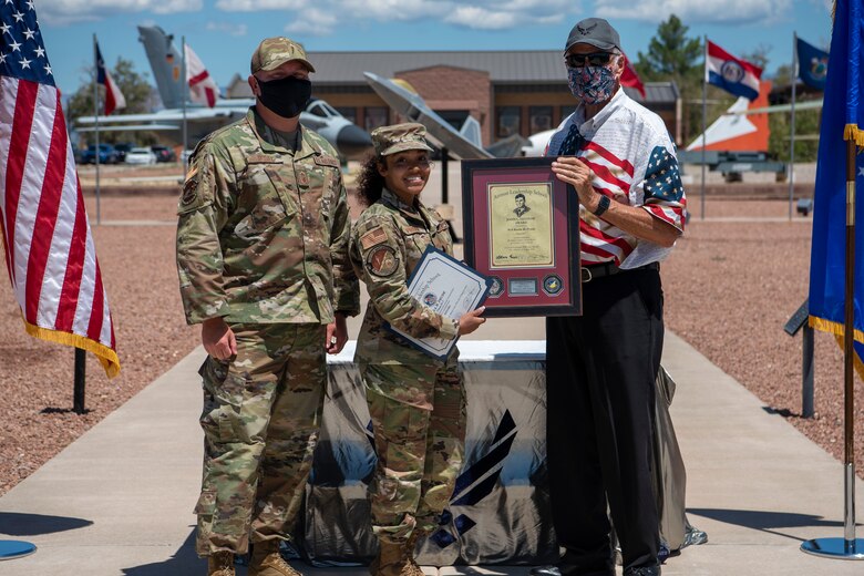 Senior Airman Kaela M. Prude, Airman Leadership School graduate, accepts the John L. Levitow award during the graduation of ALS class 21-7, Aug. 19, 2021, on Holloman Air Force Base, New Mexico. The John L. Levitow award is presented to the student demonstrating the highest level of leadership and scholastic performance, and is partially determined by the assignment of points by their peers. (U.S. Air Force photo by Airman 1st Class Jessica Sanchez)
