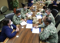 Medical providers from Navy Medicine Readiness and Training Command Bethesda speak with Deborah Spell, the director of emergency services at Ochsner Lafayette General Medical Center during their in-processing for COVID-19 response operations in Lafayette, Louisiana, Aug. 18, 2021.