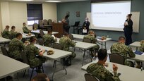 A medical support team from Navy Medicine Readiness and Training Command, Bethesda, Maryland attends an orientation brief during their initial in processing at Ochsner Lafayette General Medical Center during   COVID-19 response operations in Lafayette, Louisiana, Aug. 18, 2021.
