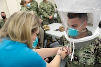 Navy Mass Communication Specialist 2nd Class Michael Lehman, assigned to Joint Task Force Civil Support (JTF-CS) public affairs, gets fit tested for an N-95 respirator during COVID-19 response operations in Lafayette, Louisiana, Aug. 18, 2021.