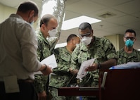 U.S. Navy. Capt. Sean McKay, a physician from Navy Medicine Readiness and Training Command Bethesda and the medical support team senior medical officer, looks over the medical supplies available in the intensive care unit during a tour of Ochsner Lafayette General Medical Center as part of the COVID response operations in Lafayette, Louisiana, Aug. 19, 2021.