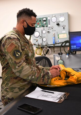 Staff Sgt. James Jackson, 9th Physiological Support Squadron aircrew flight equipment crew member, checks part of a full pressure suit  Aug. 4, 2021, at Beale Air Force Base, California.