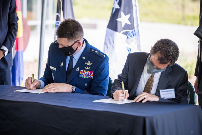 Vice Chief of Space Operations Gen. David D. Thompson and University of Colorado President Todd Saliman sign a Memorandum of Understanding Aug. 20, 2021 at the Ent Center for the Arts Garden at the University of Colorado at Colorado Springs, Colorado. (Photo by Jeffrey M Foster)