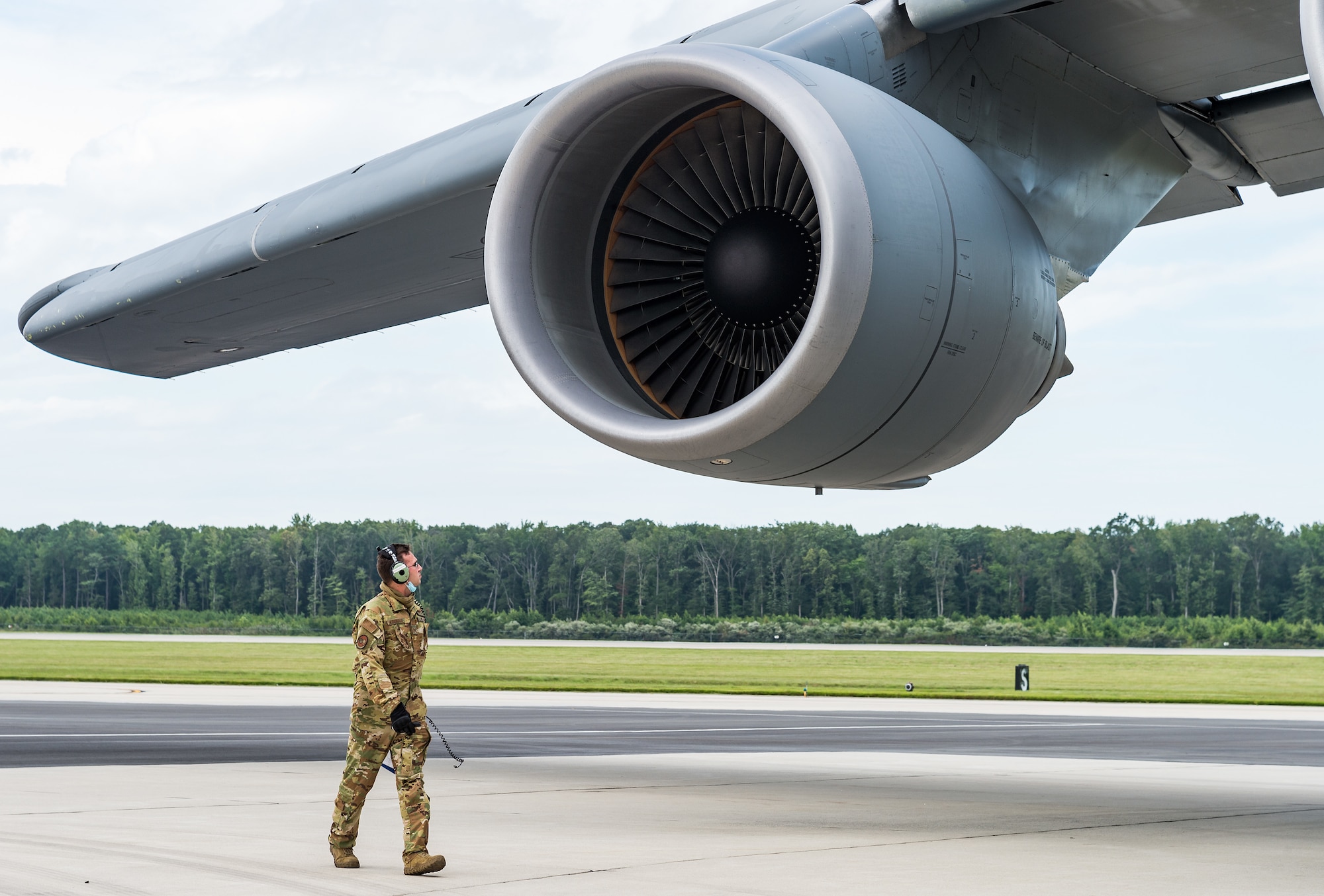 Staff Sgt. Broden McDonald, 9th Airlift Squadron flight engineer, looks at a C-5M Super Galaxy engine while performing a preflight inspection at Dover Air Force Base, Delaware, Aug. 18, 2021. The C-5M has four F-138-GE100 General Electric engines, each capable of producing 51,250 pounds of thrust. The Super Galaxy is a strategic transport aircraft and is the largest aircraft in the U.S. Air Force inventory. (U.S. Air Force photo by Roland Balik)