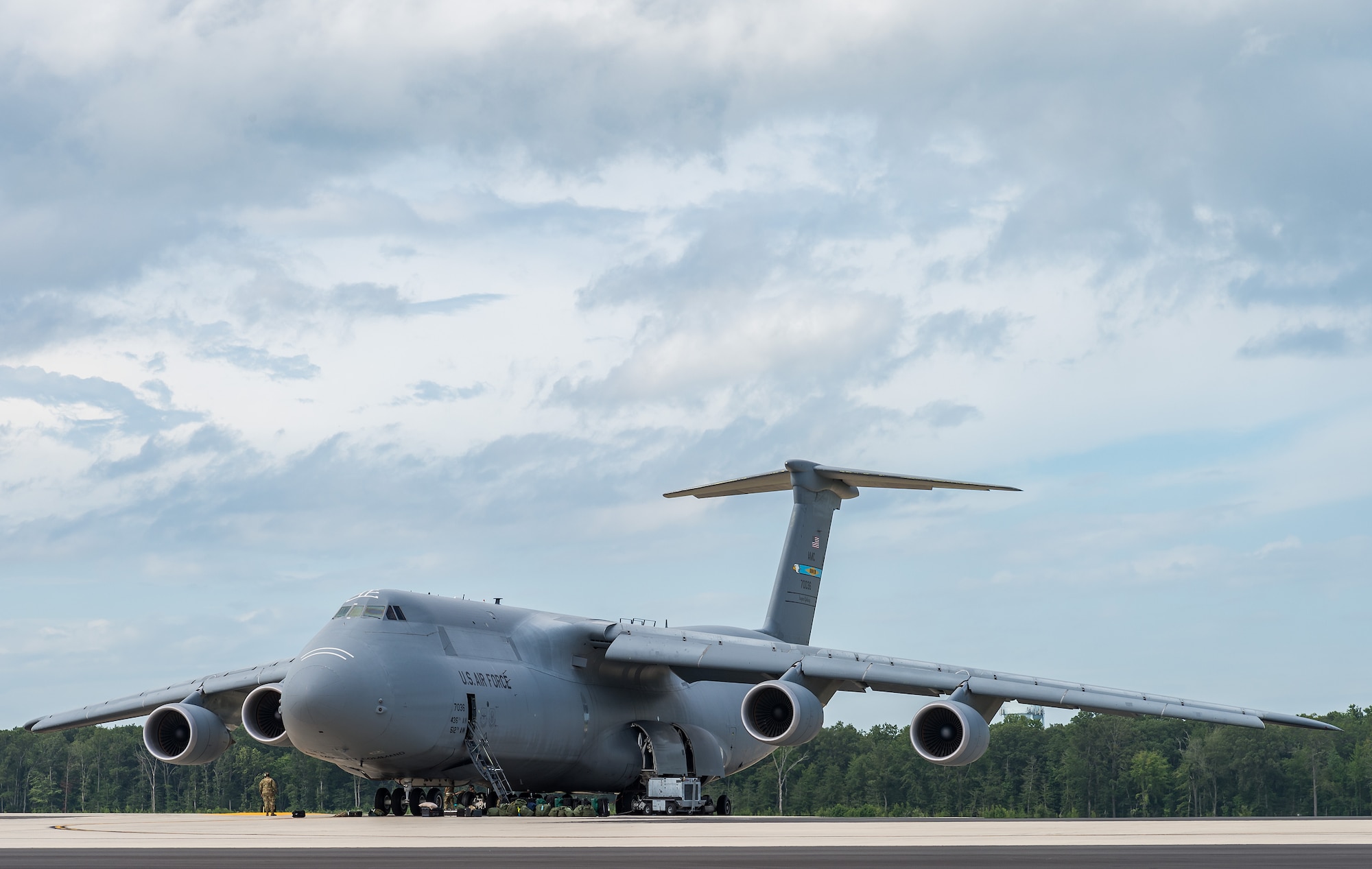 Team Dover members refuel and service a C-5M Super Galaxy prior to its departure from Dover Air Force Base, Delaware, Aug. 18, 2021. The C-5M is a strategic transport aircraft and is the largest aircraft in the U.S. Air Force inventory. (U.S. Air Force photo by Roland Balik)