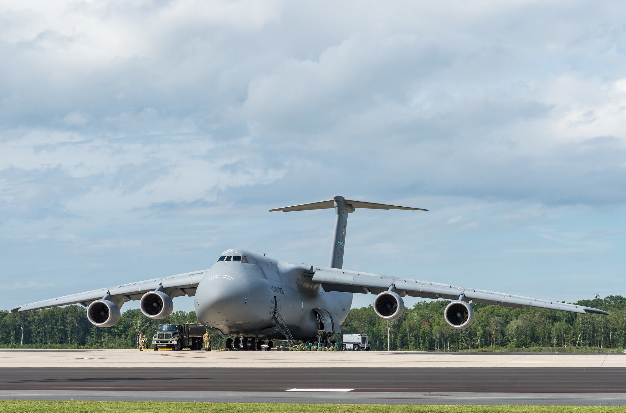 Personnel from the 436th Aircraft Maintenance and 436th Logistics Readiness Squadrons refuel a C-5M Super Galaxy prior to its departure from Dover Air Force Base, Delaware, Aug. 18, 2021. The C-5M is a strategic transport aircraft and is the largest aircraft in the U.S. Air Force inventory. (U.S. Air Force photo by Roland Balik)
