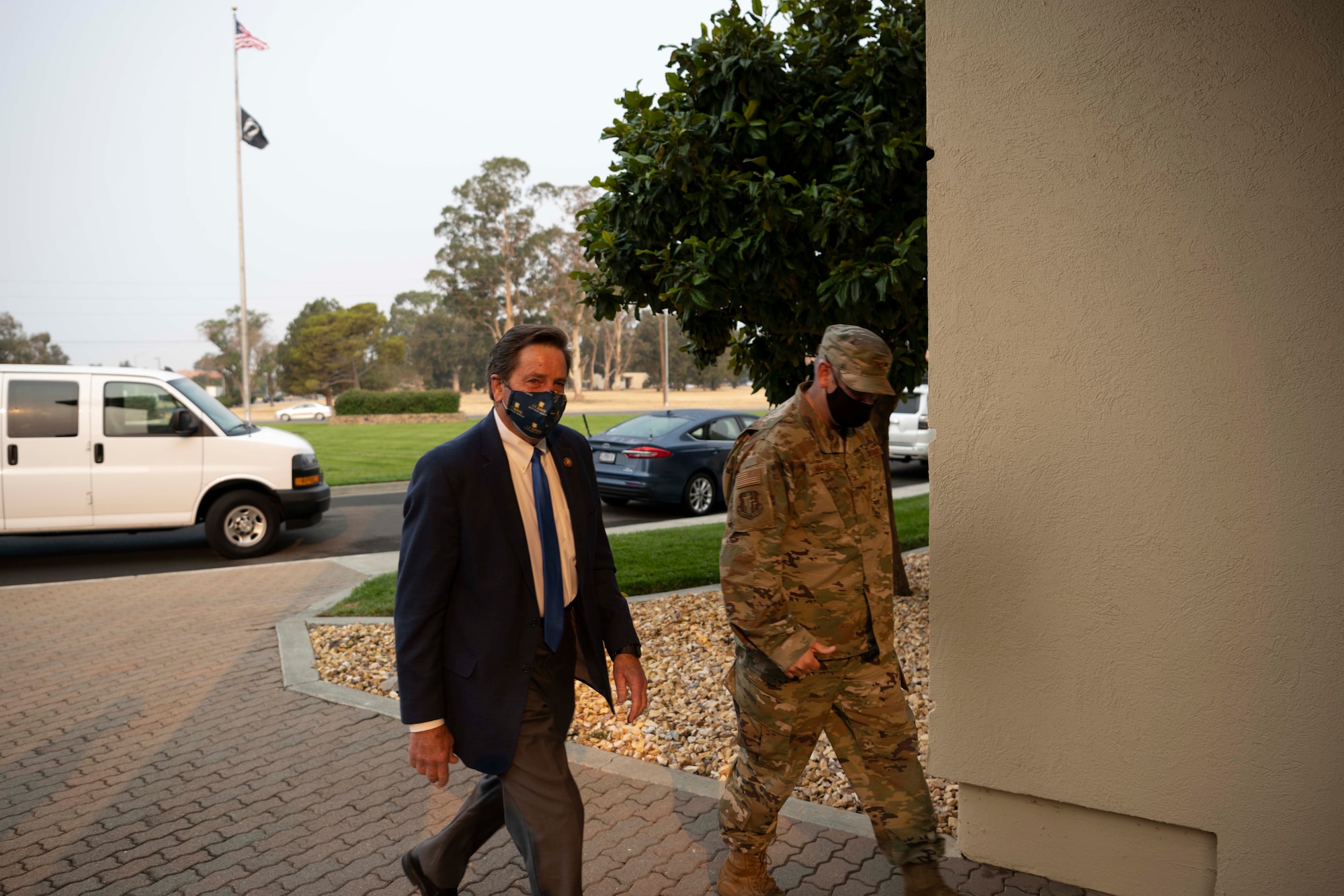 Two men walking into a building