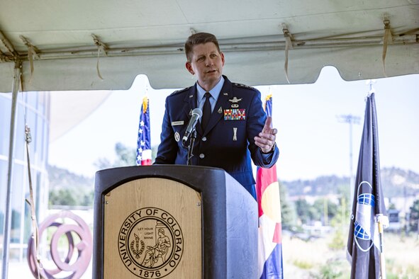 A man speaks at a lectern.