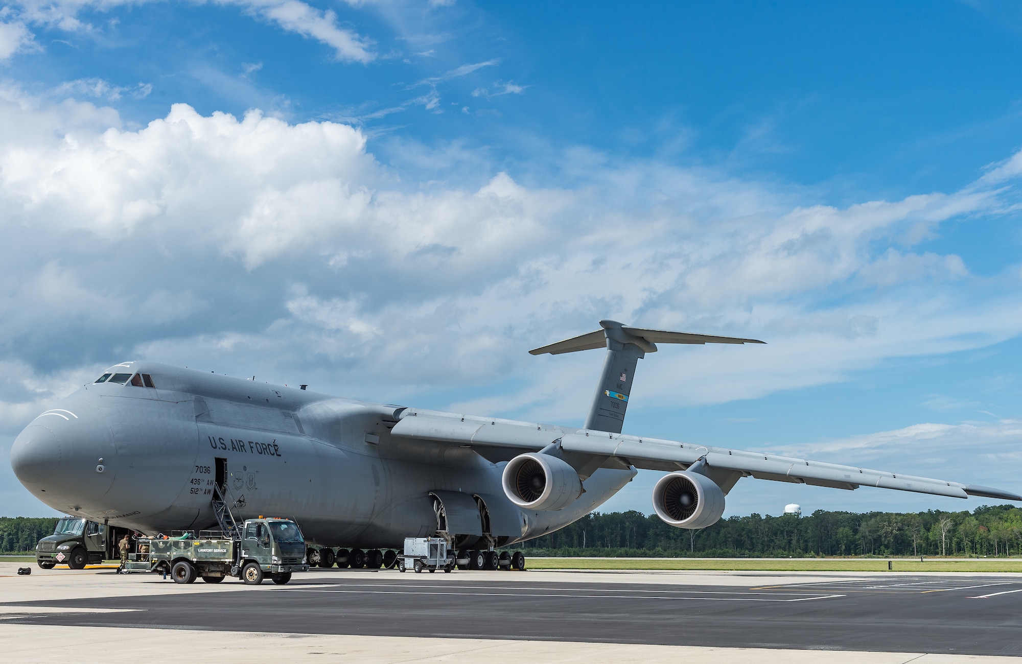 Team Dover members refuel and service a C-5M Super Galaxy prior to its departure from Dover Air Force Base, Delaware, Aug. 18, 2021. The C-5M is a strategic transport aircraft and is the largest aircraft in the U.S. Air Force inventory. (U.S. Air Force photo by Roland Balik)