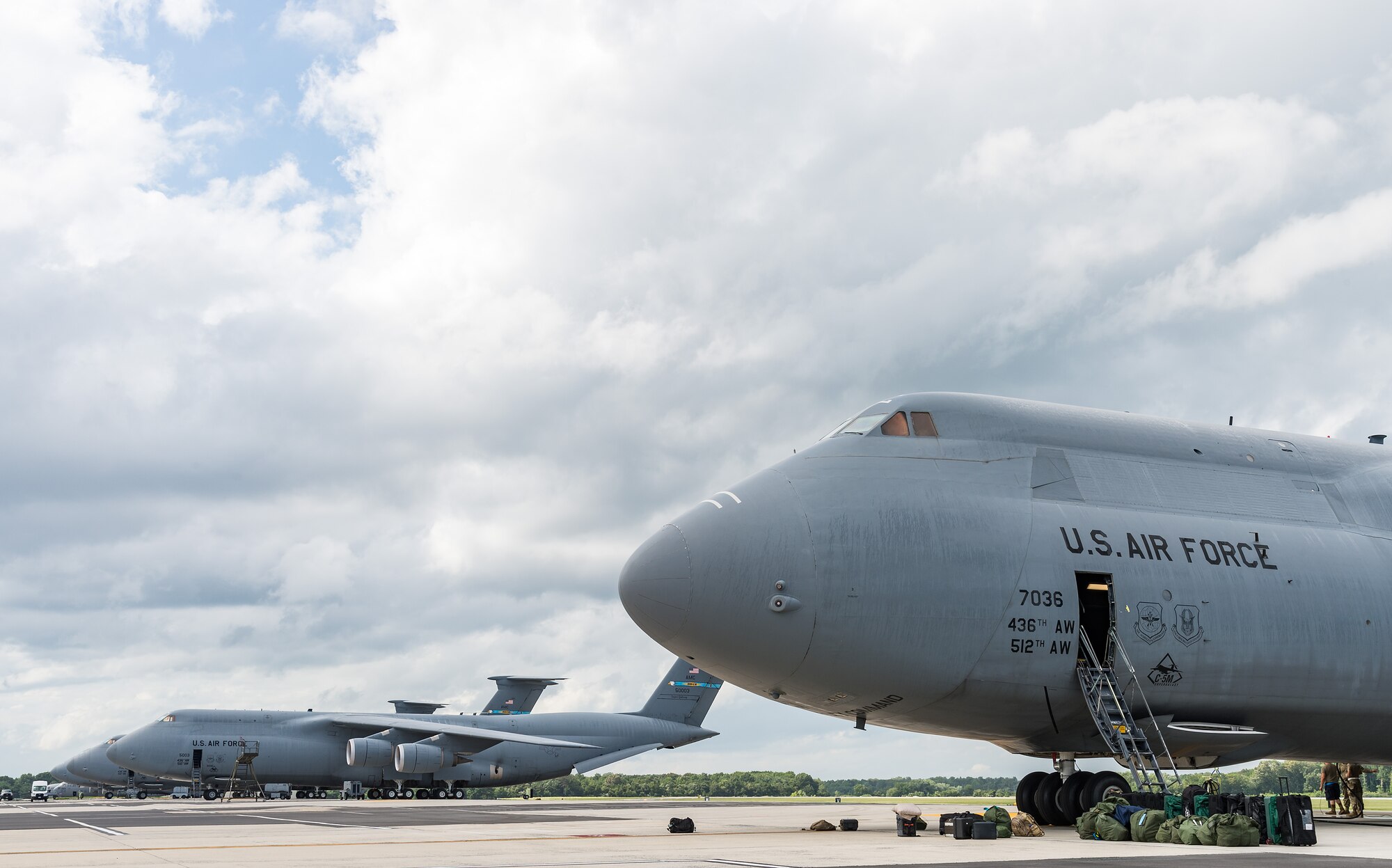 Aircrew luggage and professional gear bags sit near the bottom of the crew entrance door of a C-5M Super Galaxy prior to its departure from Dover Air Force Base, Delaware, Aug. 18, 2021. A Super Galaxy aircrew consists of a pilot, co-pilot, two flight engineers and three loadmasters on a normal mission. The C-5M is a strategic transport aircraft and is the largest aircraft in the U.S. Air Force inventory. (U.S. Air Force photo by Roland Balik)