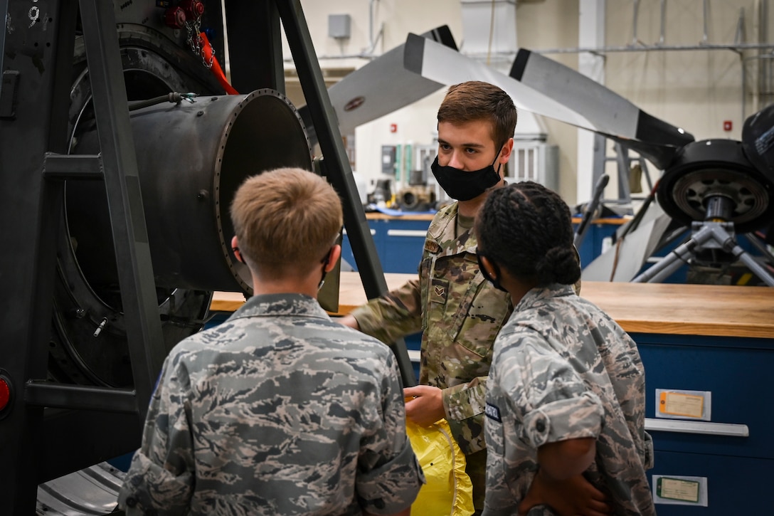 Senior Airman Thomas Sousa, 103rd Maintenance Squadron aerospace propulsion specialist, shows a C-130H Hercules engine to Civil Air Patrol cadets during a tour of Bradley Air National Guard Base in East Granby, Connecticut, Aug. 13, 2021. Cadets from the Connecticut Wing’s Danielson and Plainville squadrons got an up-close look at C-130H aircraft, the engines that power them, and learned about the 103rd Airlift Wing’s mission. (U.S. Air National Guard photo by Tech. Sgt. Steven Tucker)