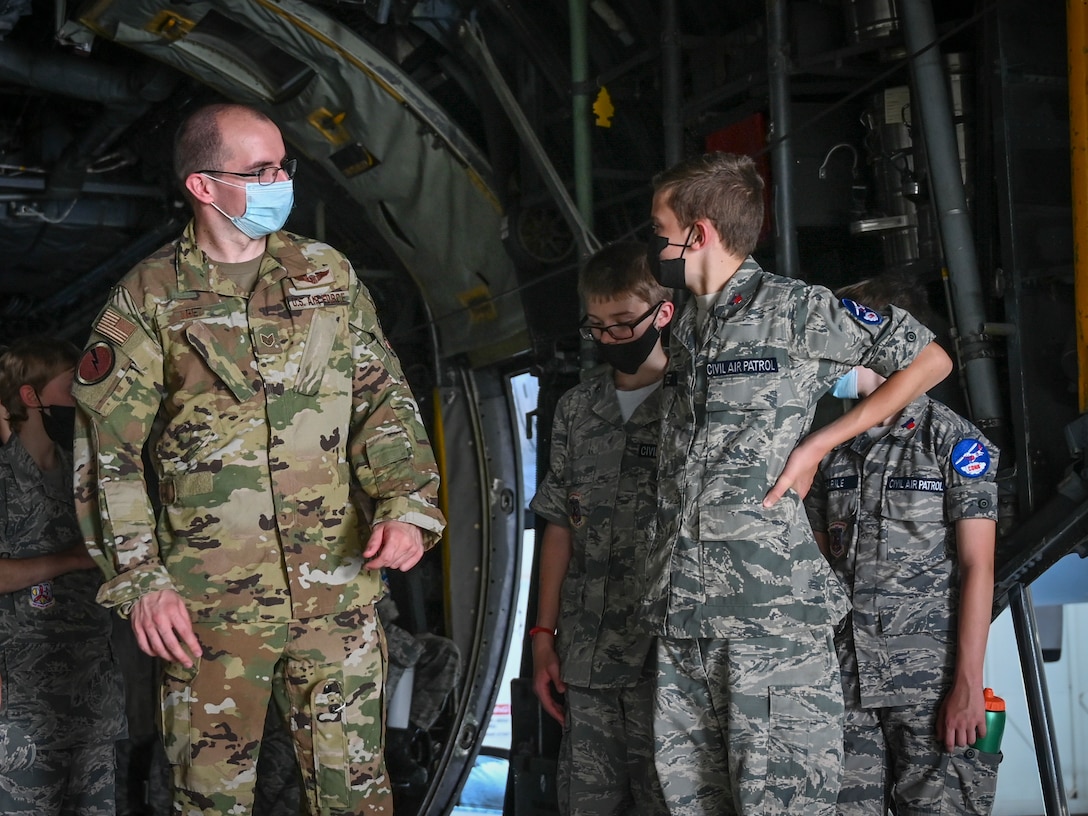 U.S. Air Force Staff Sgt. Radoslaw Kret, 118th Airlift Squadron loadmaster, talks with Civil Air Patrol cadets in the cargo bay of a 103rd Airlift Wing C-130H Hercules during a tour of Bradley Air National Guard Base in East Granby, Connecticut, Aug. 13, 2021. Cadets from the Connecticut Wing’s Danielson and Plainville squadrons got an up-close look at C-130H aircraft, the engines that power them, and learned about the 103rd Airlift Wing’s mission. (U.S. Air National Guard photo by Tech. Sgt. Steven Tucker)