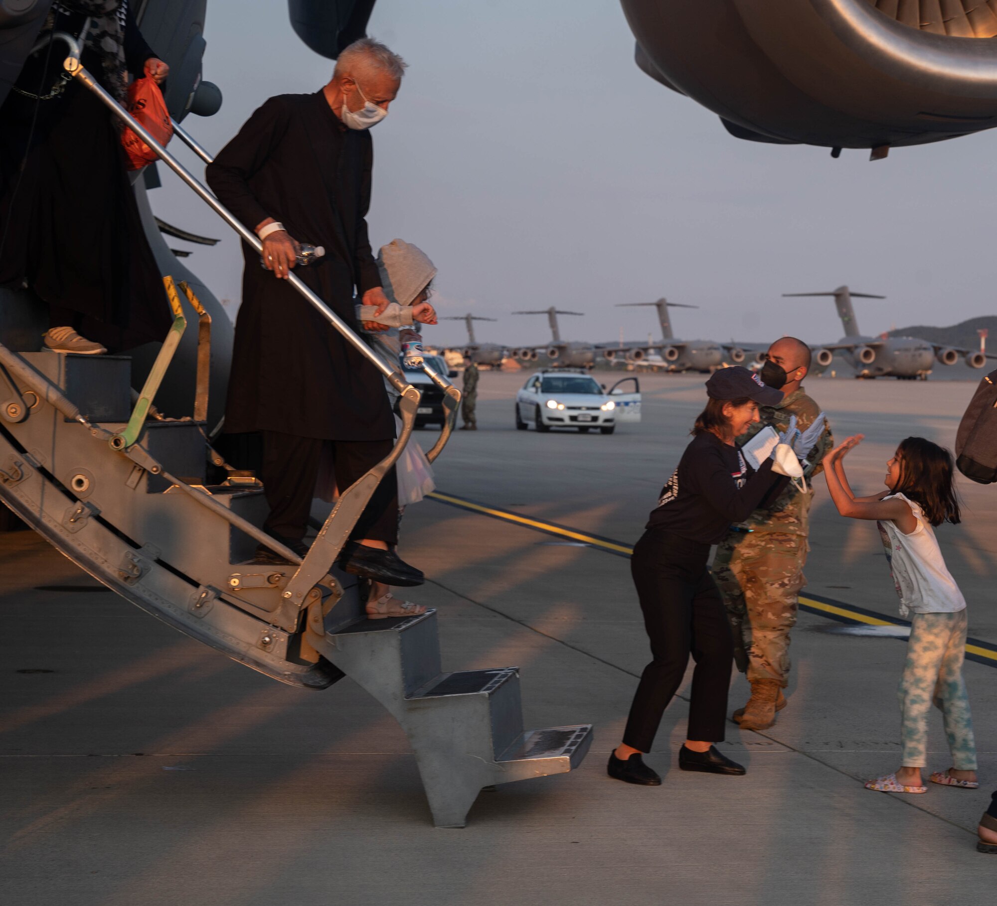 Evacuees depart aircraft.