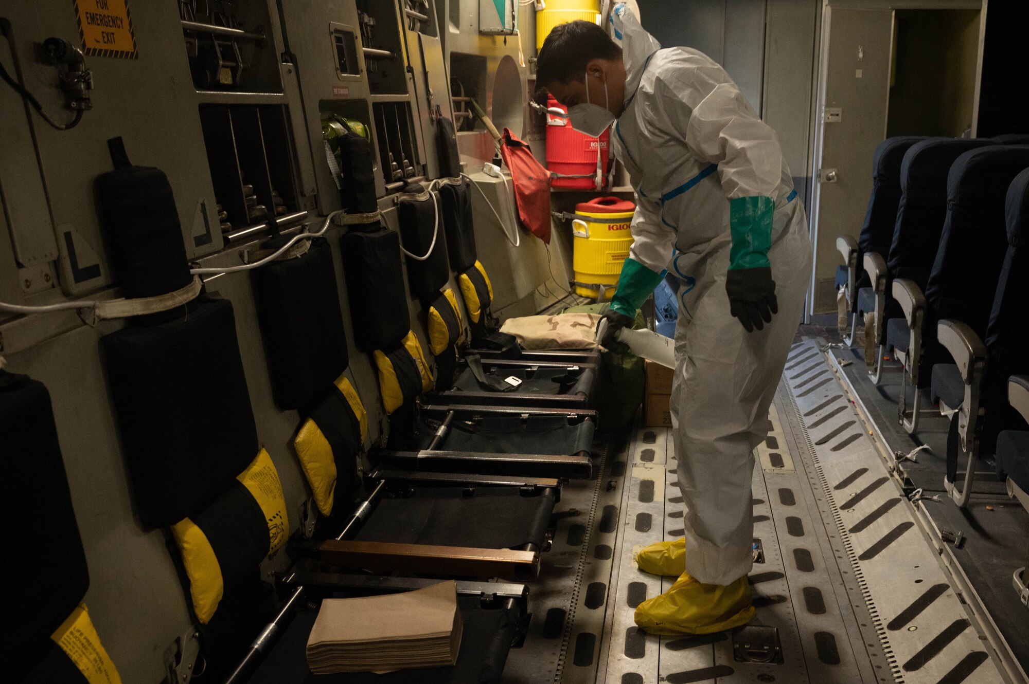 Airman sanitizes plane seats.