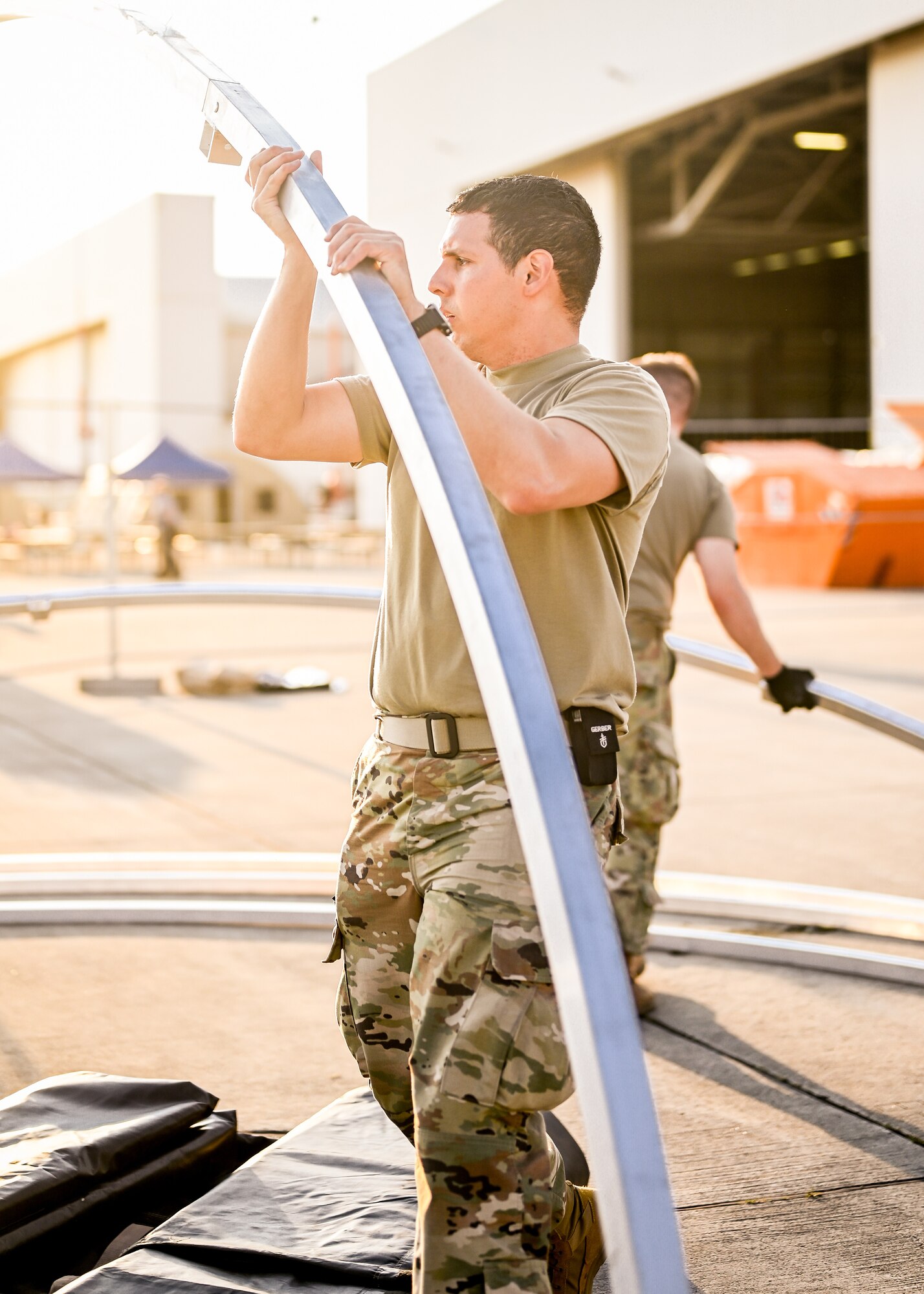 Airman preps tents.