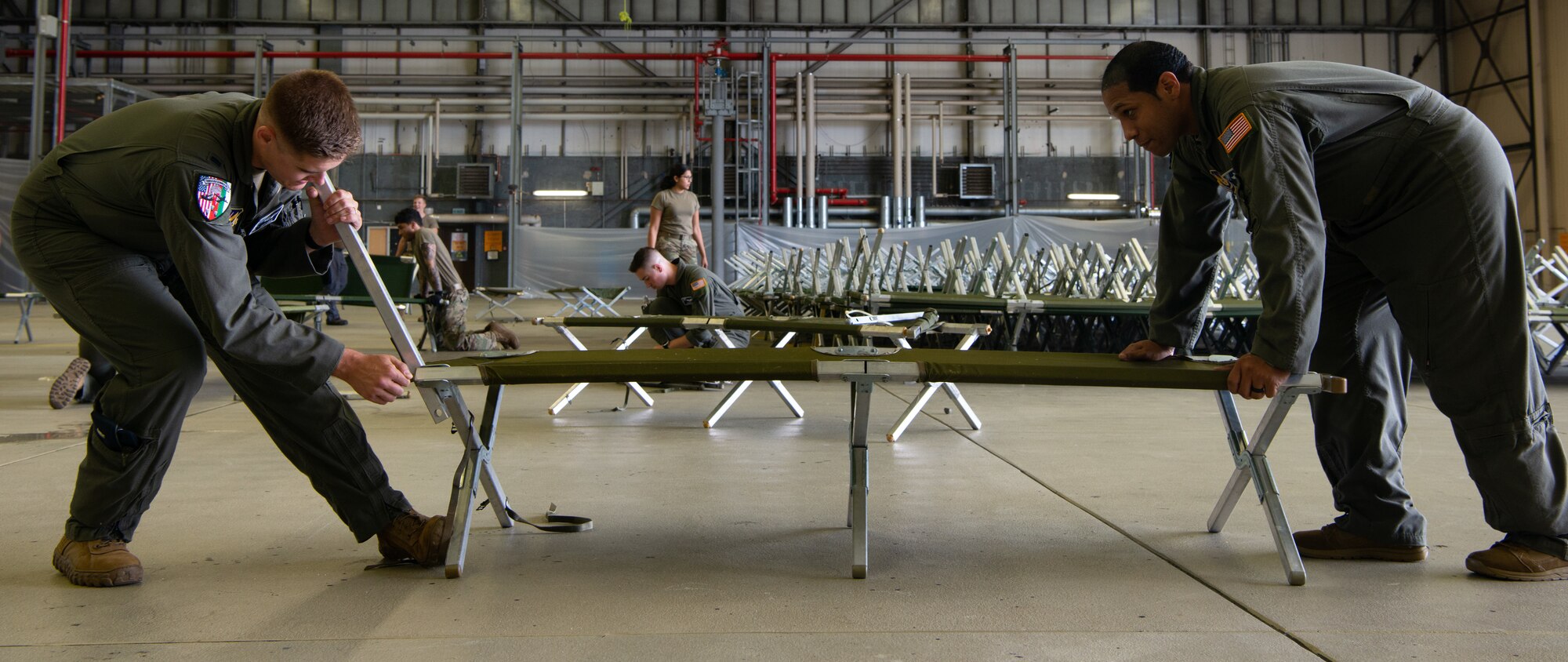 Airmen prepare cots.
