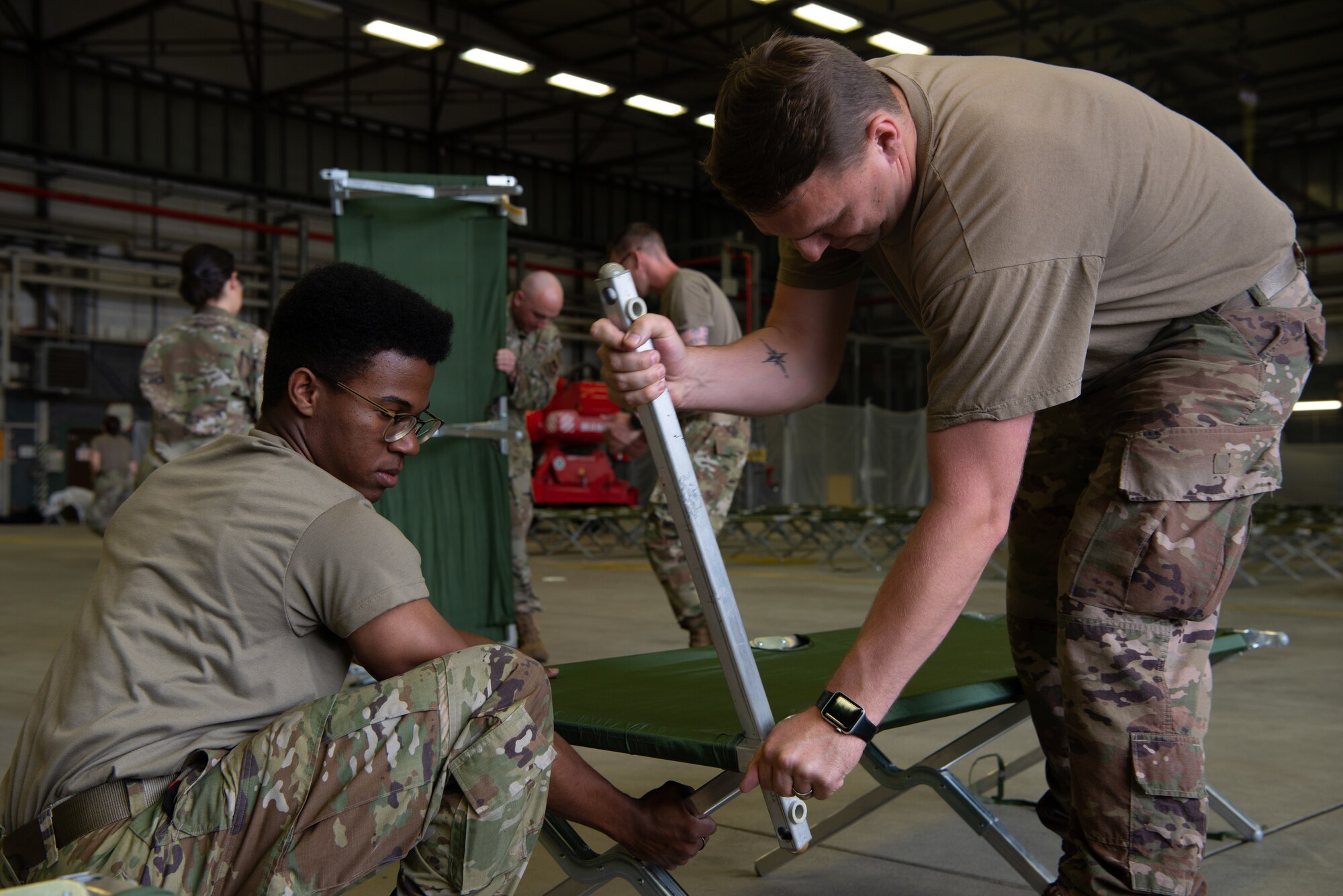 Airmen prepare cots.