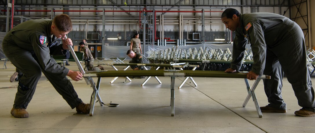 Airmen prepare cots.