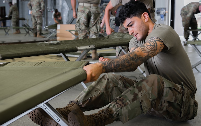 Airman sets up cots