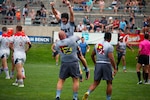 Petty Officer First Class James Irey of Marine Corps Support Facility New Orleans, La. lifts Lieut. Adam D'Amico of Navy Shipyard Portsmouth, Va. as Navy claims victory over Air Force. The 2021 Armed Forces Rugby Championship held in conjunction with the 2021 Rugbytown 7's Tournament, held from 20-22 August.  Service members from the Navy, Air Force (with Space Force personnel) and Coast Guard battle it out for gold.  (Department of Defense Photo, Released)