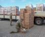 1st Lt. Meghan George (Left) and 1st Lt. Tyler Roylance (Center) from the 16th Sustainment Brigade inspect American Red Cross comfort kits downloaded at the Deployment Processing Center (DPC) on Rhine Ordnance Barracks in Kaiserslautern, Germany August 20th, 2021 in order to support the evacuation of Afghan refugees. The 21st Theater Sustainment Command supports the Department of State in the transportation, housing, and sustainment of U.S. Citizens, Special Immigrant Visa applicants, and other at-risk Afghans who are being evacuated from Afghanistan. (U.S. Army photo by Sgt. Jesse Pilgrim)