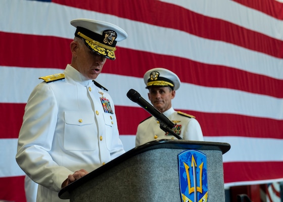 Vice Adm. Daniel Dwyer reads his orders during his Change of Command ceremony aboard the aircraft carrier USS Harry S. Truman (CVN 75) Aug. 20.