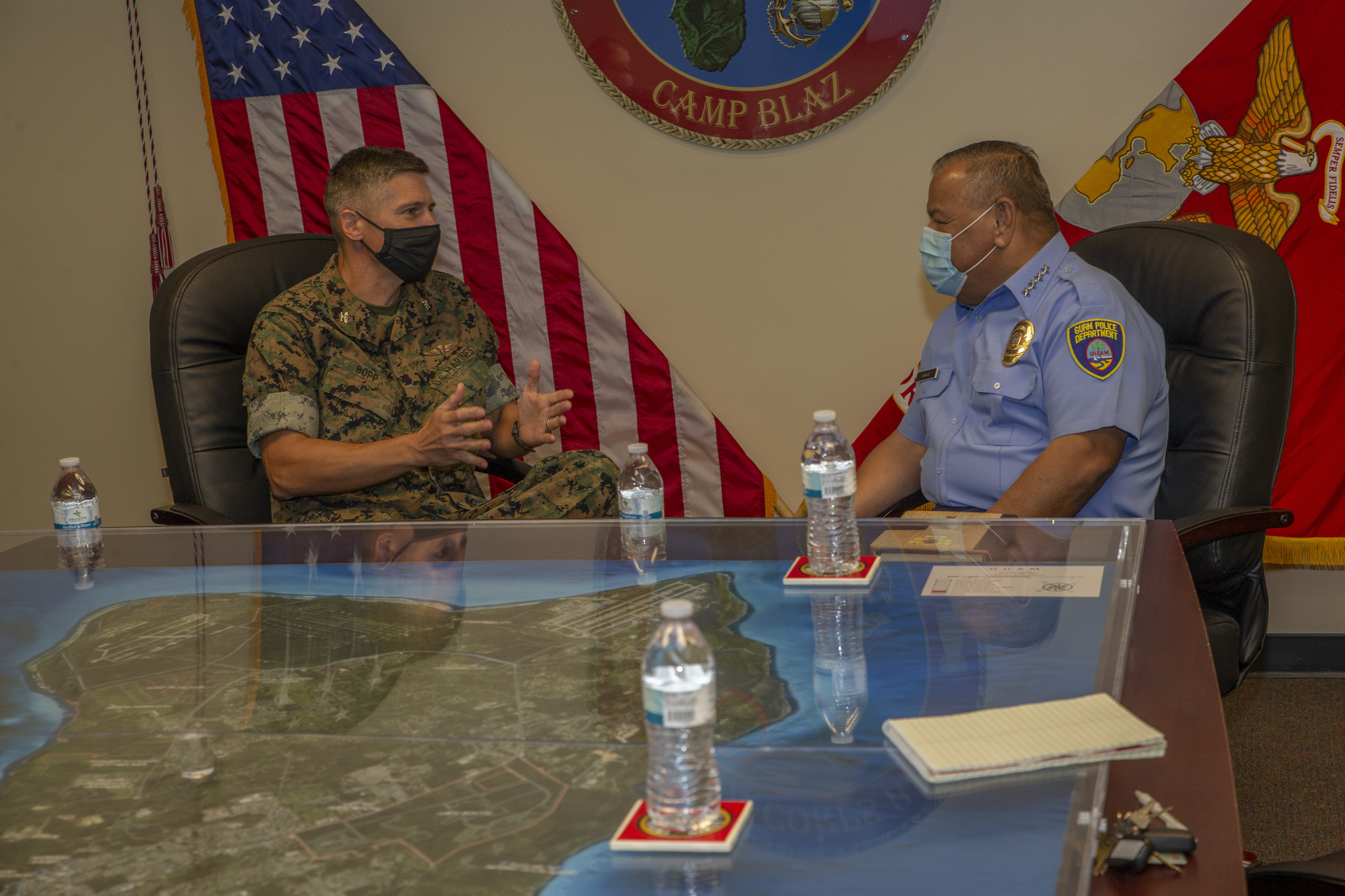 Col. Christopher Bopp, the Marine Corps Base (MCB) Camp Blaz Commanding Officer, briefs Steve Ignacio, the Guam Chief of Police, during a visit to the base, Aug. 18, 2021.