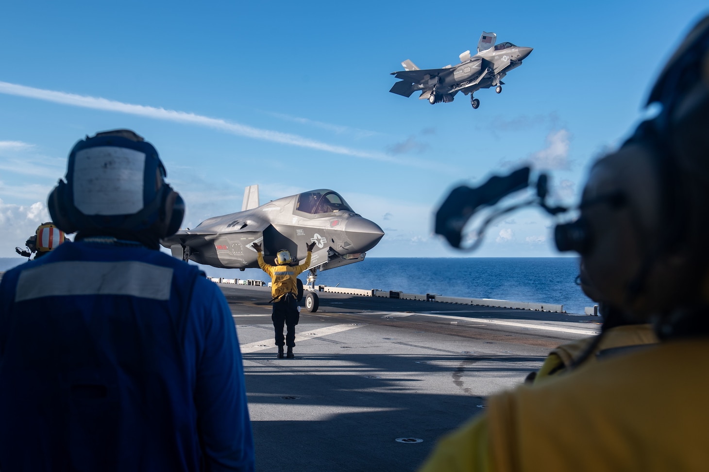 PHILIPPINE SEA (Aug. 20, 2021) An F-35B Lightning II fighter aircraft from Marine Fighter Attack Squadron (VMFA) 211, embarked on the Royal Navy aircraft carrier HMS Queen Elizabeth (R08), lands on the flight deck of the forward-deployed amphibious assault ship USS America (LHA 6) during flight operations between and America and the Royal Navy. America, flagship of the America Expeditionary Strike Group, along with the 31st Marine Expeditionary Unit, is operating in the U.S. 7th Fleet area of responsibility to enhance interoperability with allies and partners and serve as a ready response force to defend peace and stability in the Indo-Pacific region. (U.S. Navy photo by Mass Communication Specialist 3rd Class Matthew Cavenaile)