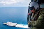 STRAIT OF MALACCA (AUG. 14, 2021) Naval Aircrewman (Helicopter) 2nd Class Nicolas Lopez from Artesia, Calif., keeps a lookout during flight operations inside of a MH-60S Seahawk helicopter assigned to the “Blackjacks” of Helicopter Sea Combat Squadron (HSC) 21 aboard the Independence-variant littoral combat ship USS Tulsa (LCS 16), Aug. 14, 2021. In its 20th year, SEACAT is a multilateral exercise designed to enhance cooperation among 21 participating Southeast Asian countries and provide mutual support and a common goal to address crises, contingencies, and illegal activities in the maritime domain in support of a free and open Indo-Pacific. (U.S. Navy photo by Mass Communication Specialist 3rd Class Richard Cho)
