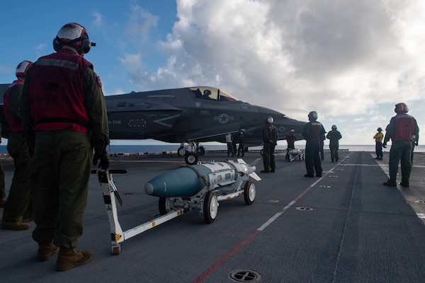 PHILIPPINE SEA (Aug. 20, 2021) Marines from the 31st Marine Expeditionary Unit (MEU) prepare to load inert ordnance into F-35B Lightning II fighter aircraft from Marine Fighter Attack Squadron (VMFA) 211, embarked on the Royal Navy aircraft carrier HMS Queen Elizabeth (R08), during flight operations between the forward-deployed amphibious assault ship USS America (LHA 6) and the Royal Navy. America, flagship of the America Expeditionary Strike Group, along with the 31st MEU, is operating in the U.S. 7th Fleet area of responsibility to enhance interoperability with allies and partners and serve as a ready response force to defend peace and stability in the Indo-Pacific region. (U.S. Navy photo by Mass Communication Specialist 3rd Class Matthew Cavenaile)