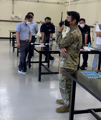 Jerry Geifer, a reachback representative from the U.S. Army Research and Development Center, demonstrates how to dial on a Tele-Engineering Communications Deployable device, during communications training at the FED motor pool, Aug. 17.