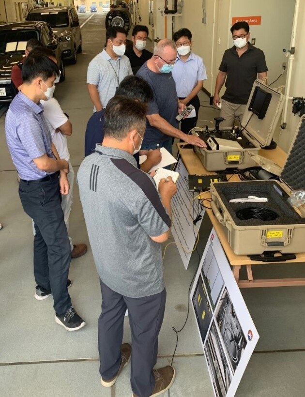 Jerry Geifer, a reachback representative from the U.S. Army Research and Development Center, demonstrates how to dial on a Tele-Engineering Communications Deployable device, during communications training at the FED motor pool, Aug. 17.