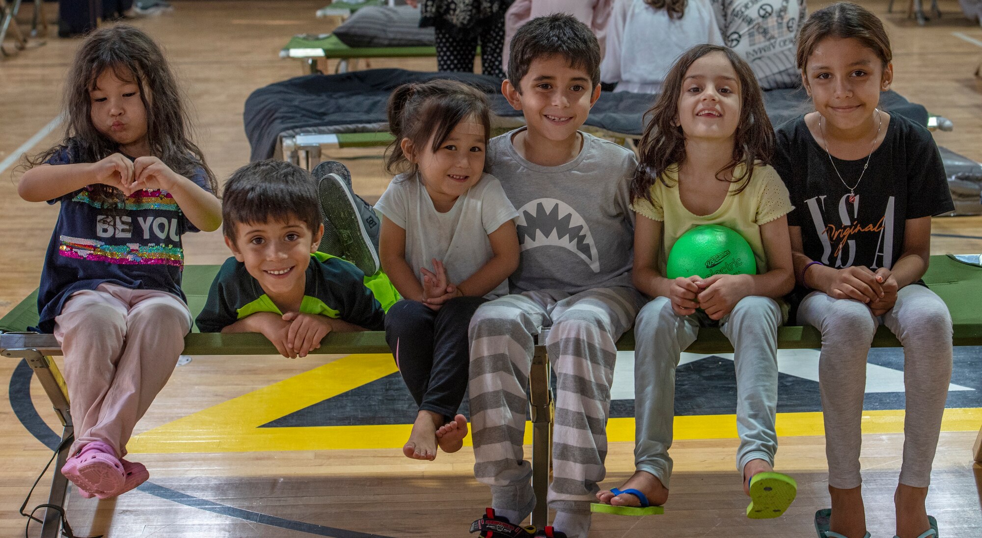 Children pose for a picture in a gym in the CENTCOM region, Aug. 20, 2021.