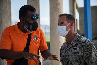 U.S. Navy Rear Adm. Keith Davids, right, U.S. Southern Command (USSOUTHCOM) Joint Task Force-Haiti commander, and Dr. Jerry Chandler, left, Director General at Direction Generale de la Protection Civile, discuss support at Port-au-Prince, Haiti, Aug. 21, 2021.