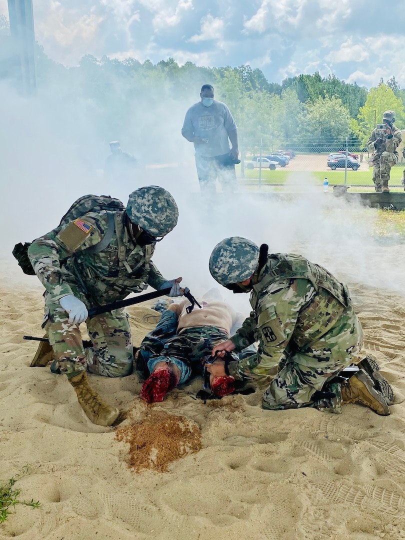 Pfc. Steven Ndong (left) and Pfc. Megan Schindler (right), 115th Field Hospital, 32nd Hospital Center, conduct tactical casualty care during a community relations engagement with Tony Kittrell, CEO, Advent Comments, at the Joint Readiness Training Center medical range, at Fort Polk, La., on Aug. 13.