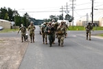 After treating the “injured” Soldiers, medics strap them to stretchers and ruck marching them to the Joint Readiness Training Center Rear Aid Station to continue the training Aug. 6.