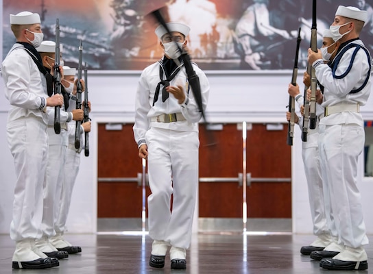 Members of the recruit drill team perform during a pass-in-review graduation ceremony at Recruit Training Command.