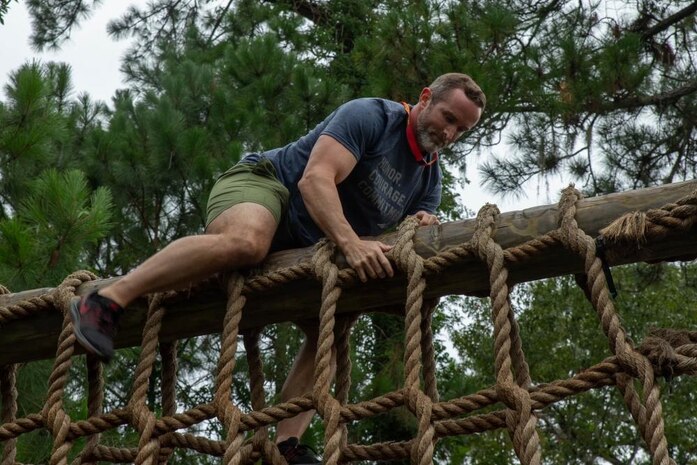 Cale Langston, District Three school board member for Wakulla County Schools in Crawfordville, Fla., traverses an obstacle during the Educator's Workshop at Marine Corps Recruit Depot Parris Island, S.C., August 4, 2021. Marine Corps Recruiting Command conducts educator workshops annually to inform high school educators, coaches, and counselors about the process of becoming a Marine and raise awareness of the opportunities for their students in the Corps.