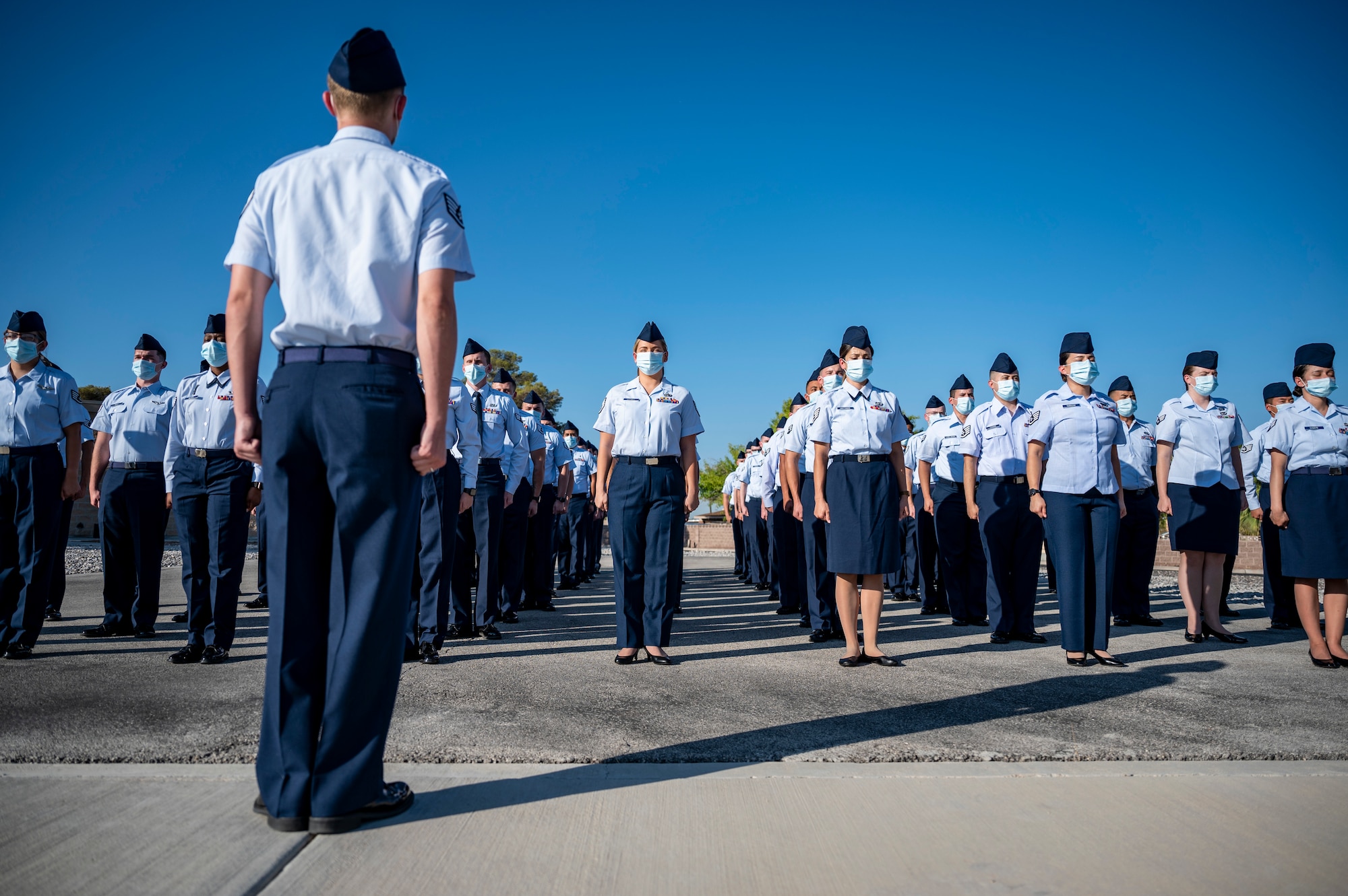 Students from the Nellis Airman Leadership School, prepare to perform reveille.