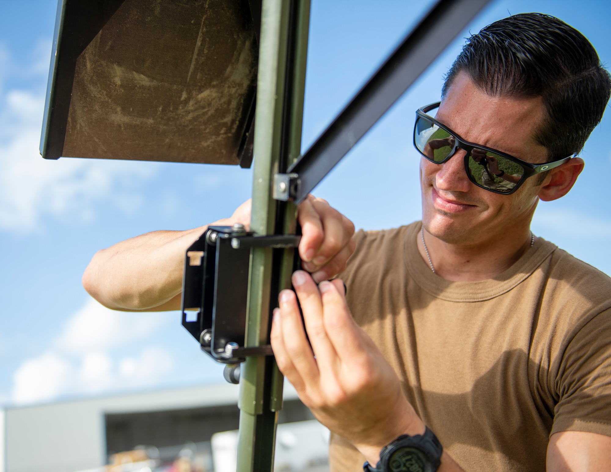 U.S. Air Force Tech. Sgt. Lee Hagan, 146th Contingency Response Flight, California Air National Guard, sets up the TMQ-53 portable weather station in St. Croix, Virgin Islands, Aug. 17, 2021.