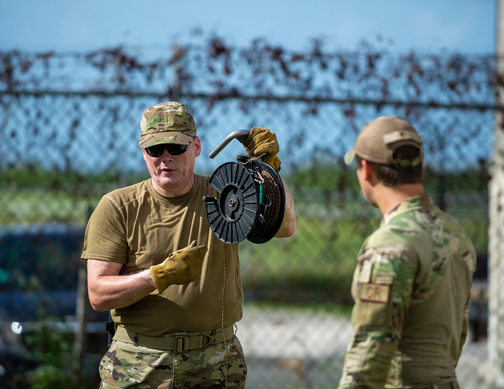 U.S. Air Force Senior Master Sgt. Troy McNear, 133rd Contingency Response Flight, Minnesota Air National Guard, left, and Tech. Sgt. Zach Wilt, 136th Contingency Response Flight, Texas Air National Guard, sets up a line-of-sight antenna in St. Croix, Virgin Islands, Aug. 17, 2021.