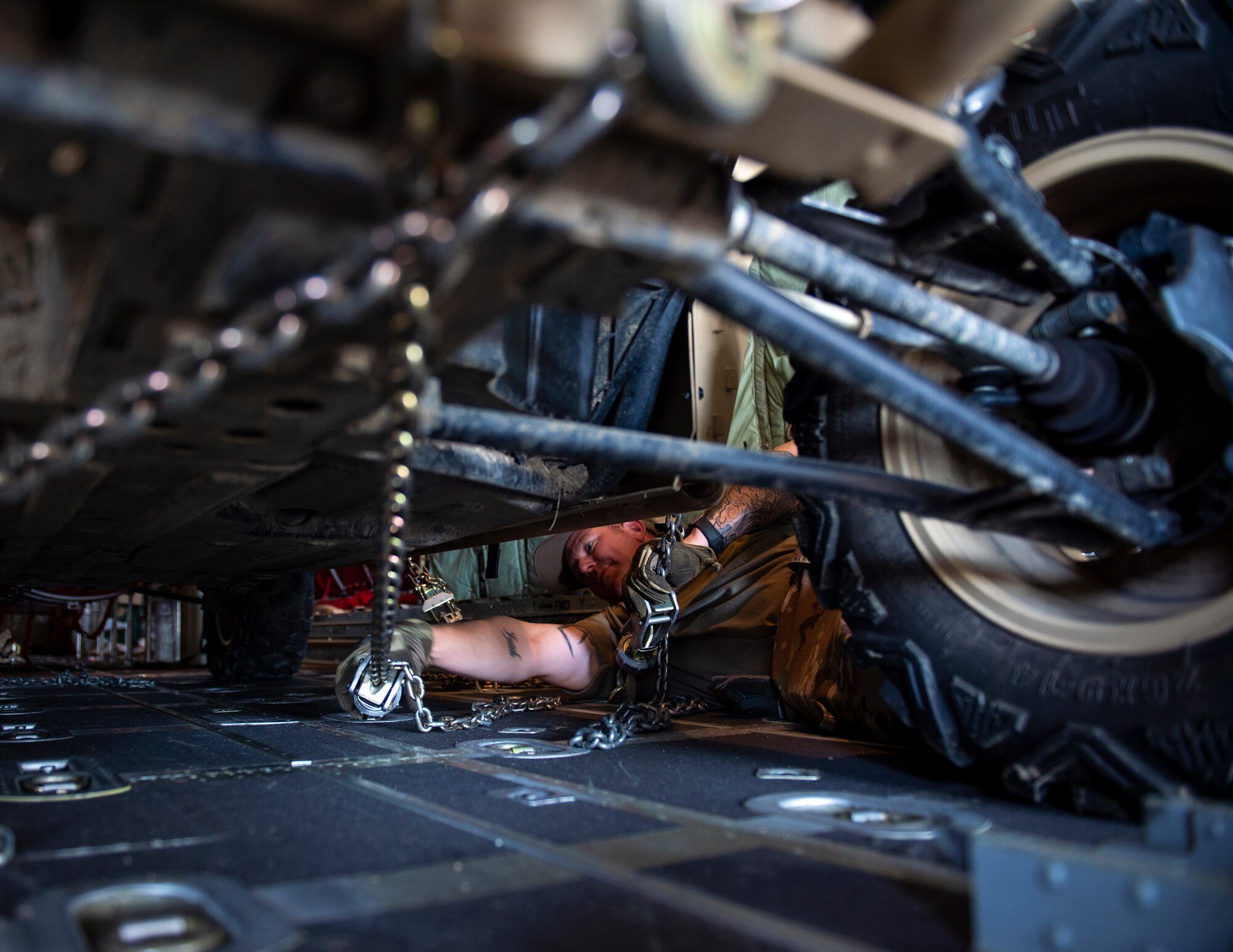 U.S. Air Force Master Sgt. James Cain, 136th Contingency Response Flight, Texas Air National Guard, securities the light tactical all-terrain vehicle (MZRZ) in a C-130 Hercules from the Minnesota Air National Guard in St. Croix, Virgin Islands, Aug. 17, 2021.