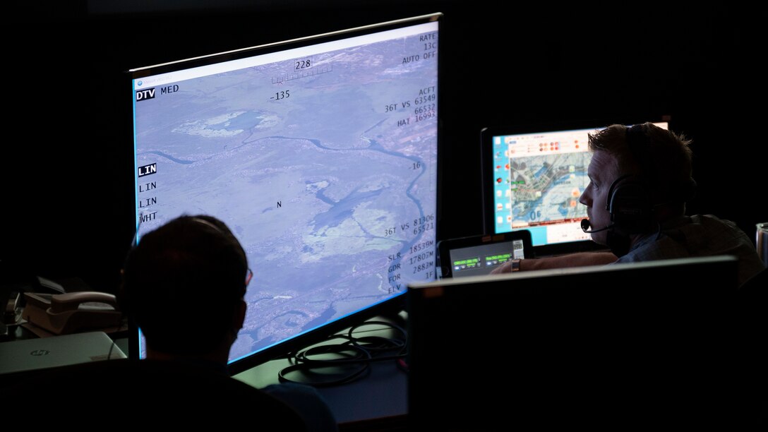 A joint terminal attack controller instructor assigned to the 492nd Special Operations Support Squadron, communicates with students CV-22 Osprey tiltrotor aircraft simulator during a training simulation for Bold Quest 21.1, at Hurlburt Field, Florida, August 12, 2021. (U.S. Air Force photo by Senior Airman Edward Coddington)