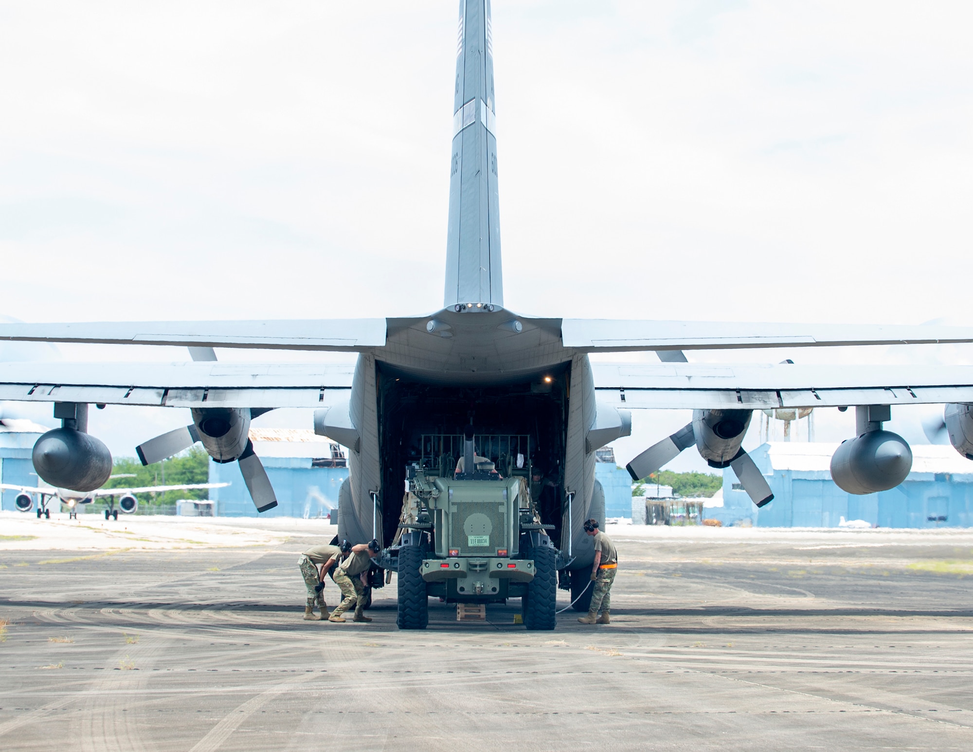 U.S. Airmen from the 123rd Contingency Response Group, Kentucky Air National Guard, loads cargo onto a C-130 Hercules from the 133rd Airlift Wing, in Aguadilla, Puerto Rico, Aug. 18, 2021.