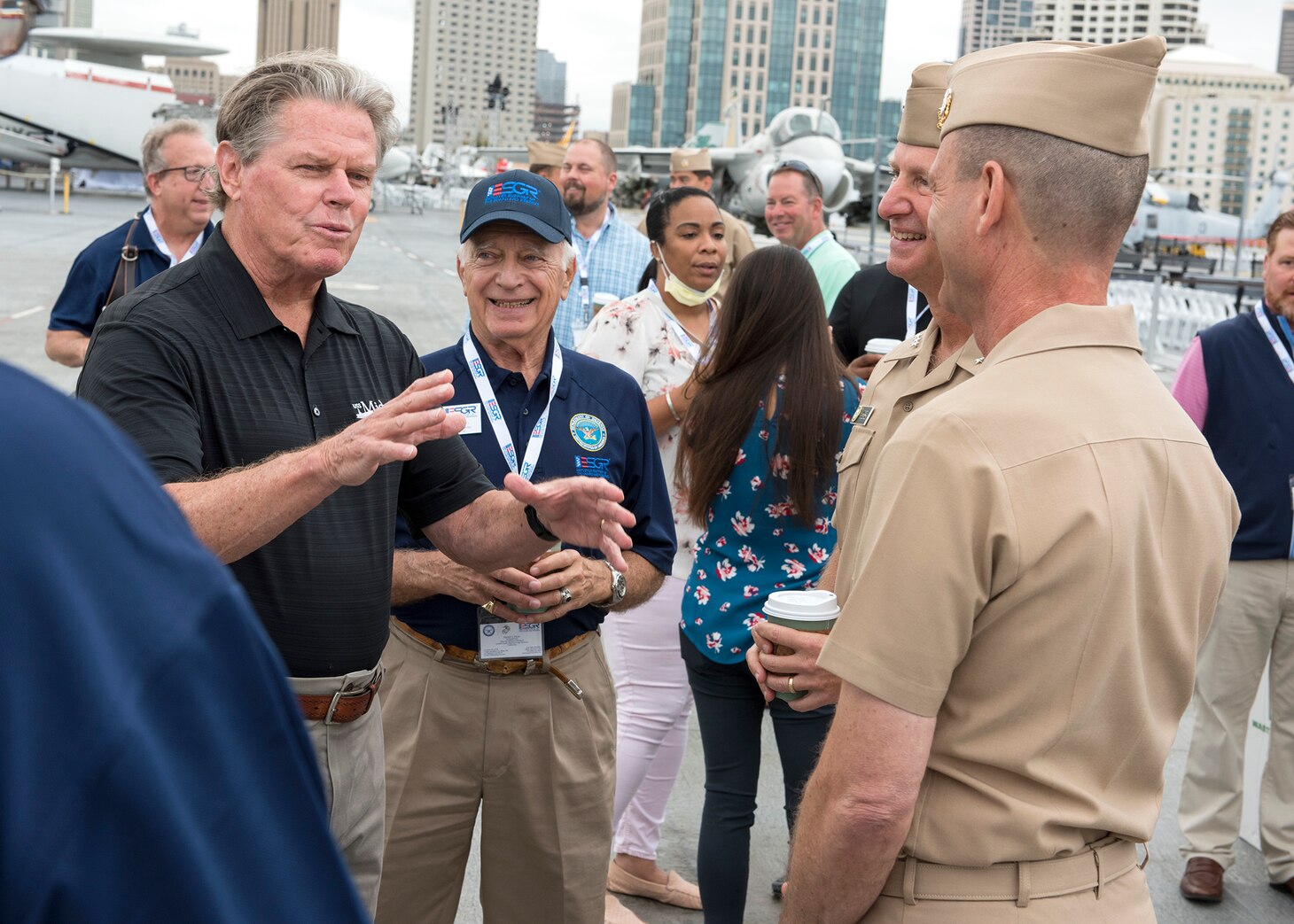 Rear Adm. John McLaughlin, USNR, retired and President and CEO of the USS Midway Museum, talks with Chief of Navy Reserve Vice Adm. John Mustin, Commander, Navy Reserve Force and Rear Adm. John Schommer, aboard USS Midway Museum during a Navy Employer Recognition Event (NERE) in San Diego, August 20, 2021. Selected employers were nominated by their Navy Reserve employees for supporting their service and especially mobilization for the nation’s response to the COVID-19 pandemic, and invited to attend the one-day event that includes a tour of Midway, a static display of aircraft at Fleet Logistics Support Squadron (VR) 57, an equipment display by Maritime Expeditionary Security Squadron 1 and SEAL Team 17. The Navy Reserve mobilized 2,875 service members in 2020 under the presidential authorization for DoD’s support to the nation’s pandemic.